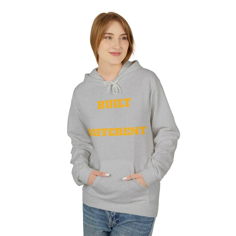 Woman wearing a gray Built Differently Blessing casual unisex hoodie with yellow text and a front pouch pocket