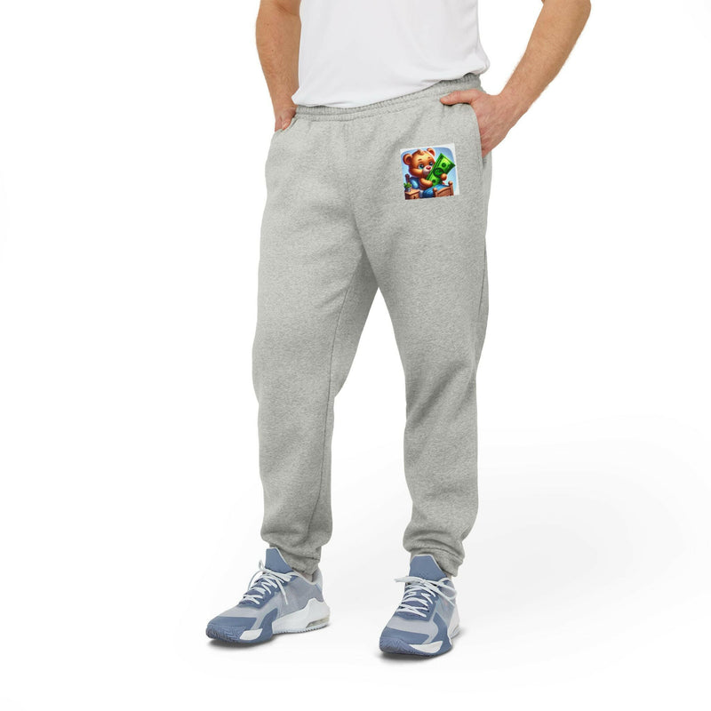 Cozy unisex fleece joggers in light gray with elastic waistband and cuffed hems, featuring slanted pockets and a small colorful patch on the thigh, styled for casual wear.