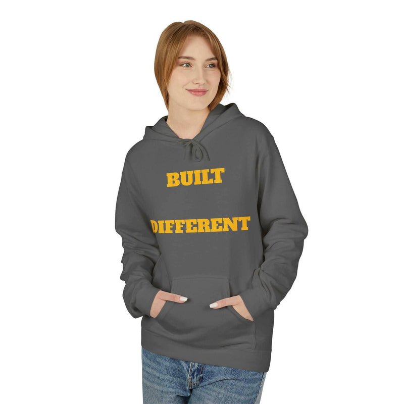 Unisex casual grey hoodie with "Built Different" yellow text, soft fleece, relaxed fit, and front pouch pocket.