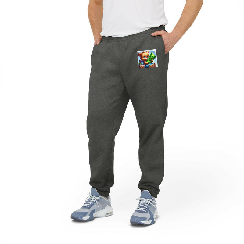 Cozy unisex fleece joggers in dark gray with elastic waistband and cuffed hems, featuring slanted side pockets and white adidas® logo.