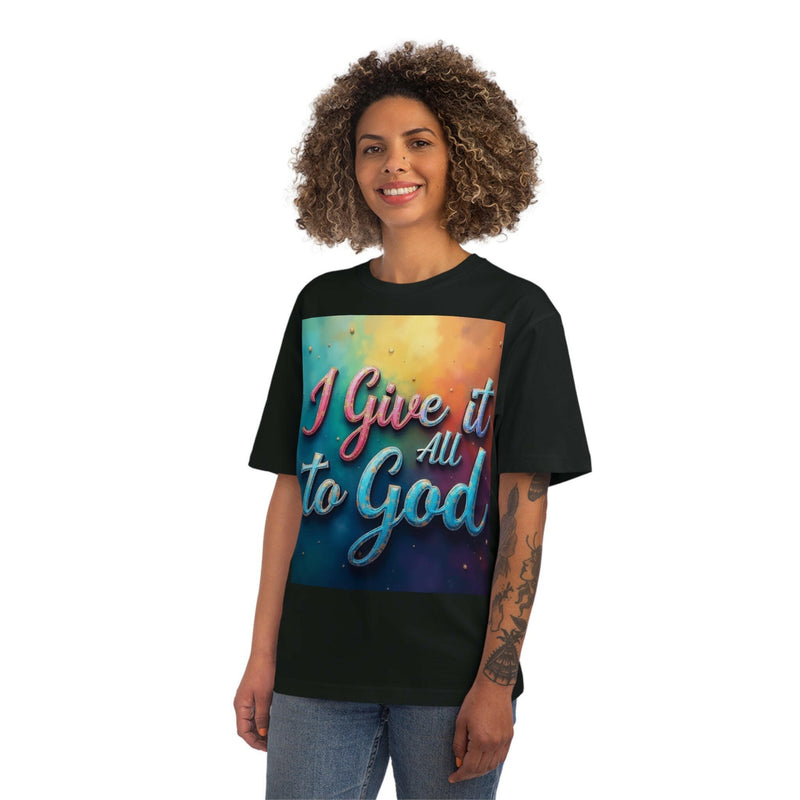 Smiling person wearing a black Inspirational Unisex Fuser T-Shirt with colorful "I Give it All to God" text on the front, styled casually