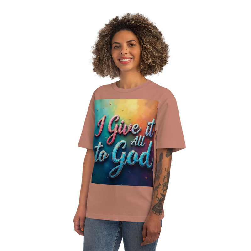 Smiling person wearing a pink Inspirational Unisex Fuser T-Shirt with "I Give it All to God" text in colorful design.