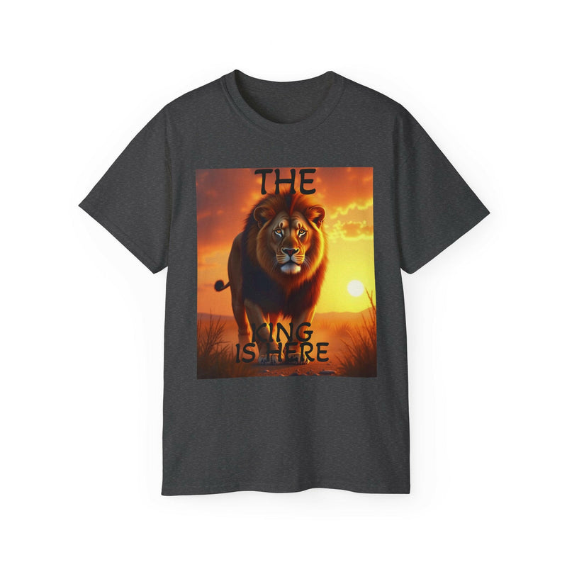 Unisex dark gray ultra cotton tee with vibrant lion graphic and bold inspirational text "The King Is Here" at sunset background